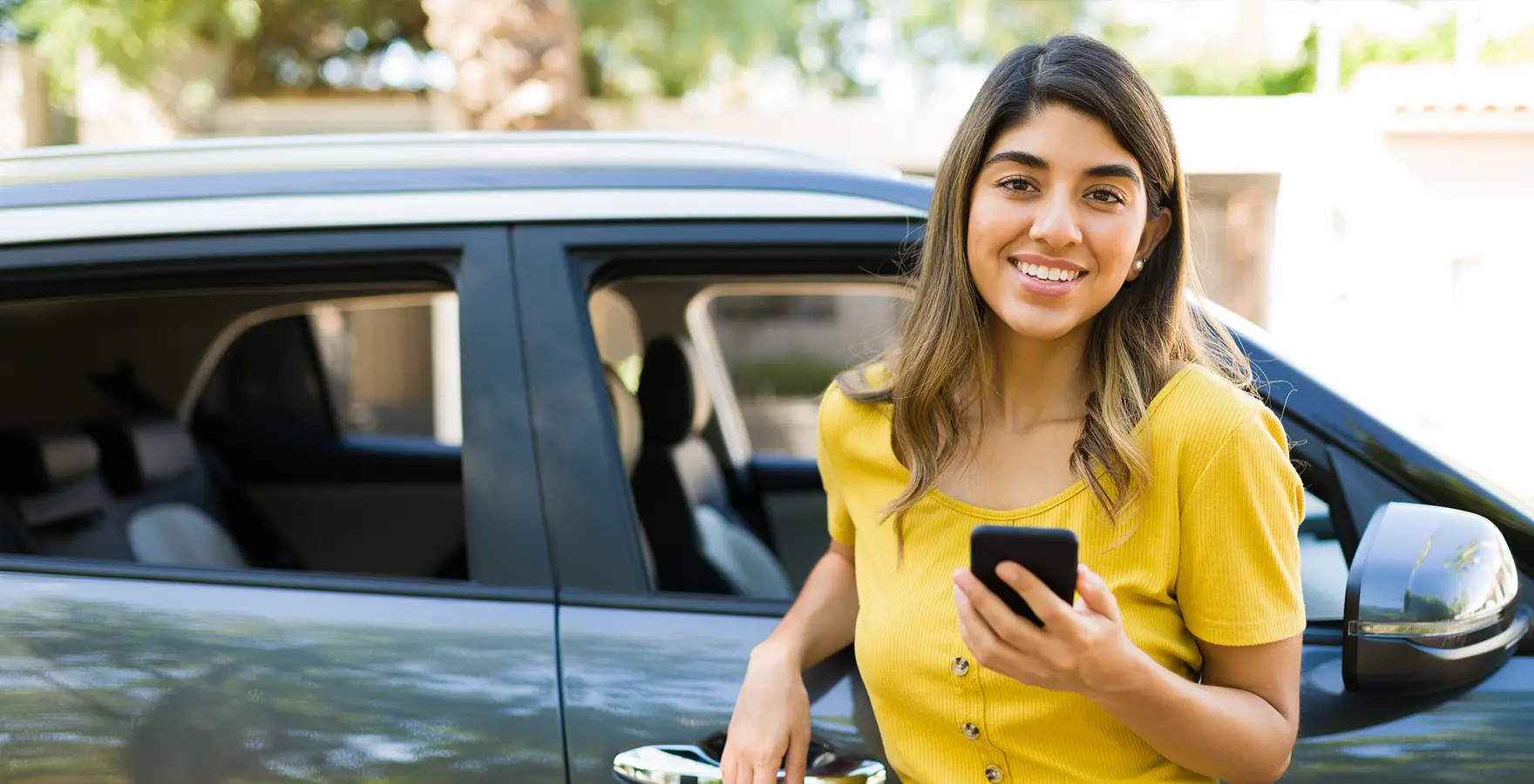 Woman standing by car