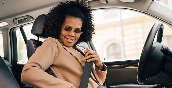 Woman putting on seatbelt