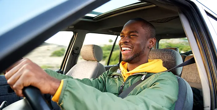 Man in green jacket driving