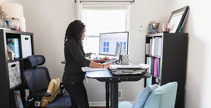 Woman in apartment researching on computer
