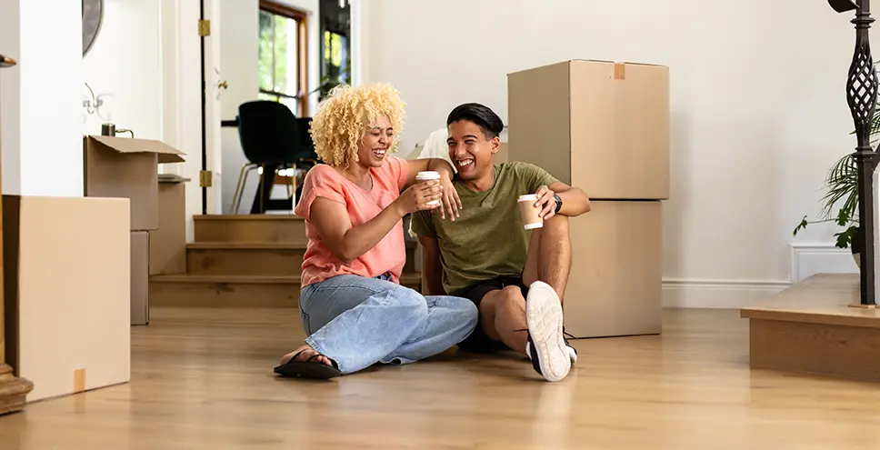Couple sitting next to moving boxes