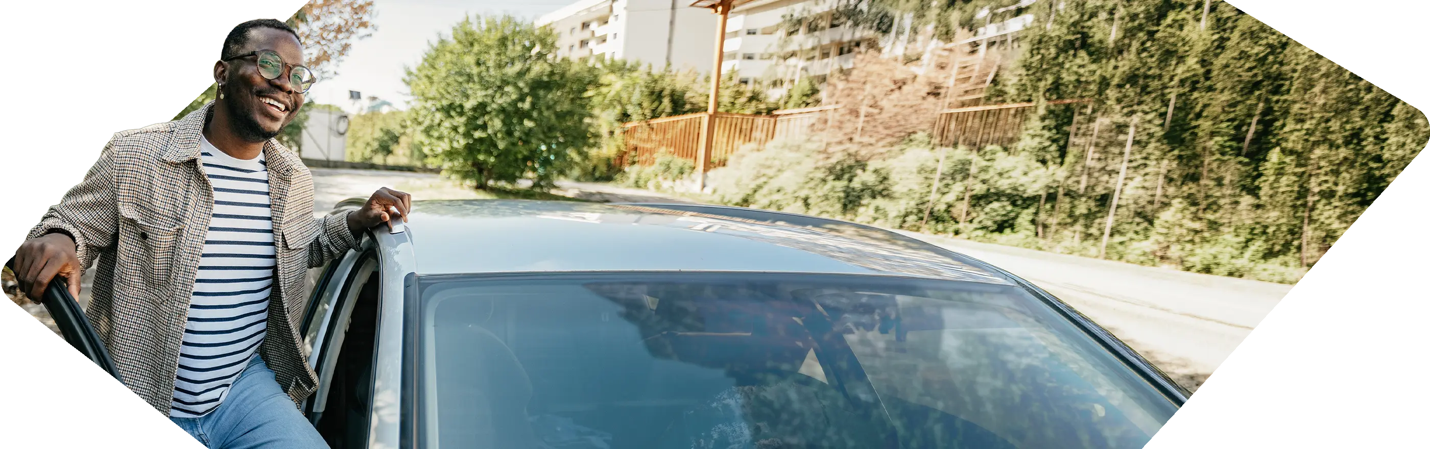 Smiling woman leaning on car
