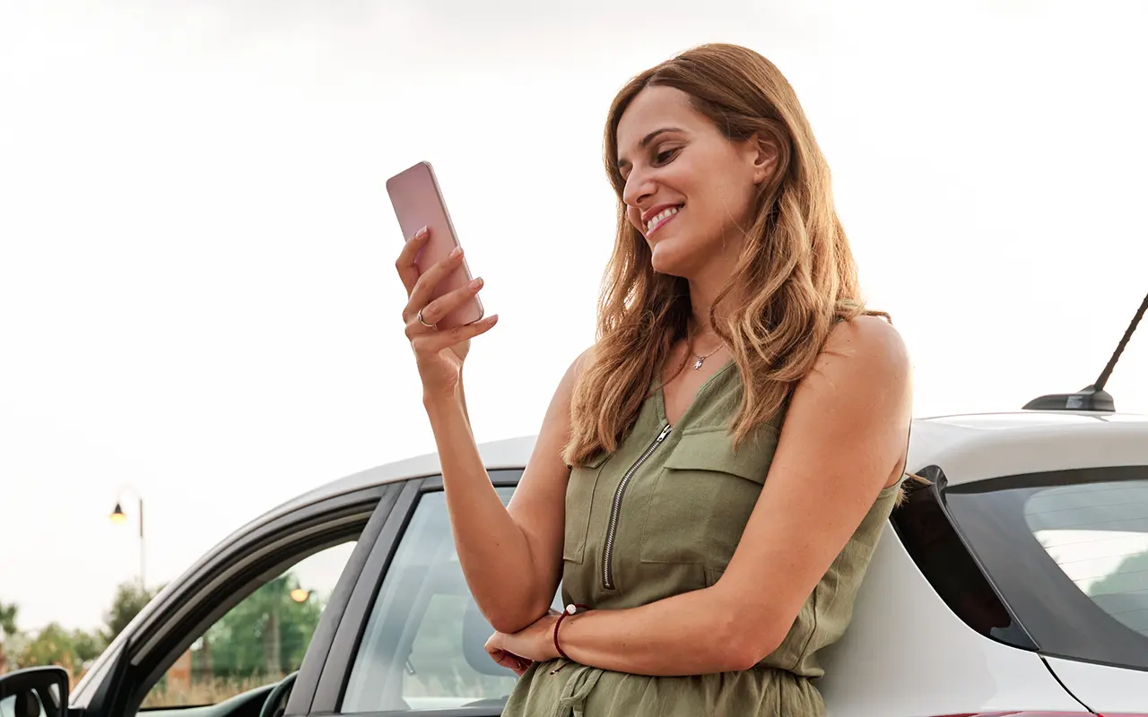 Woman standing by car