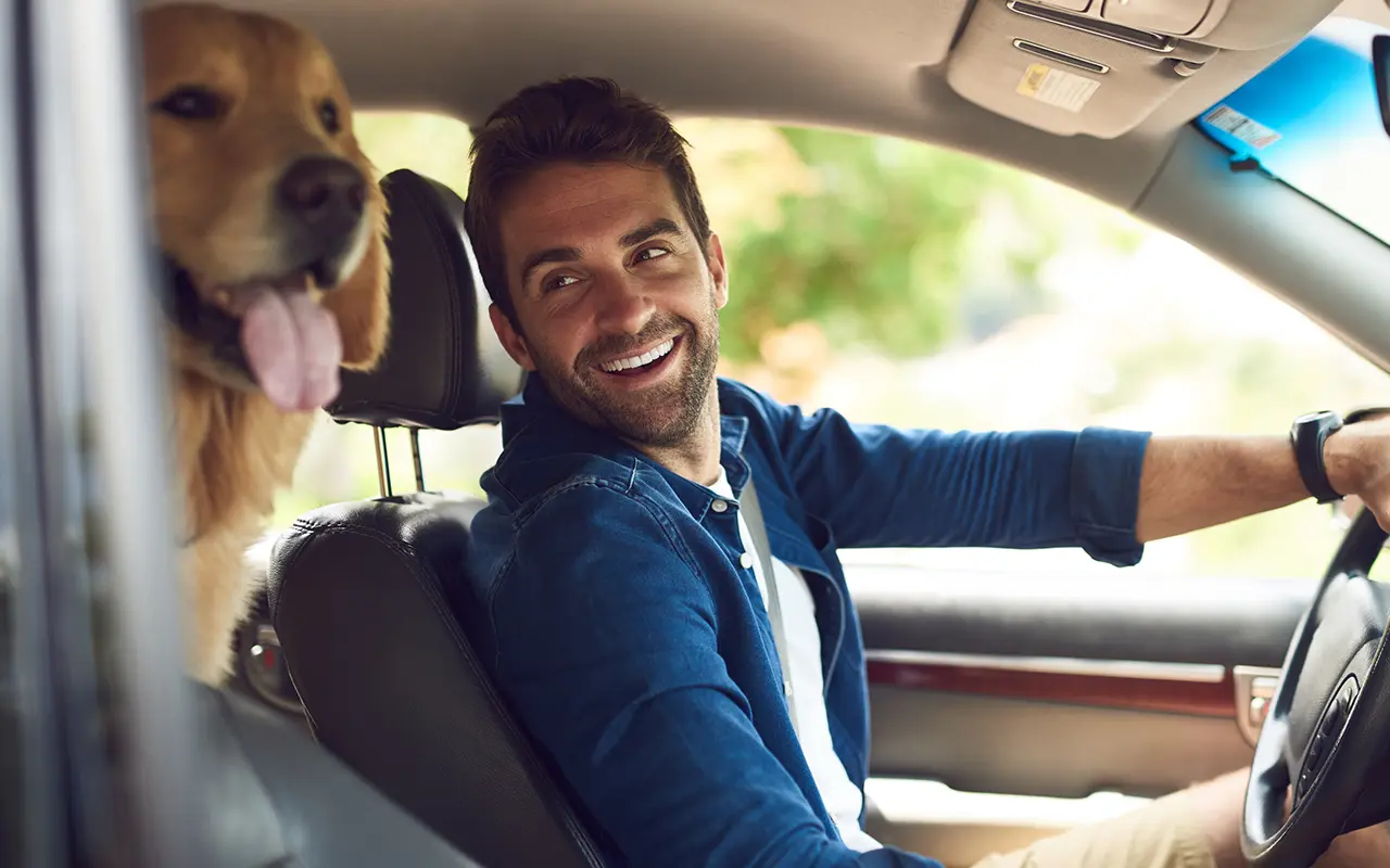 Man in car with dog